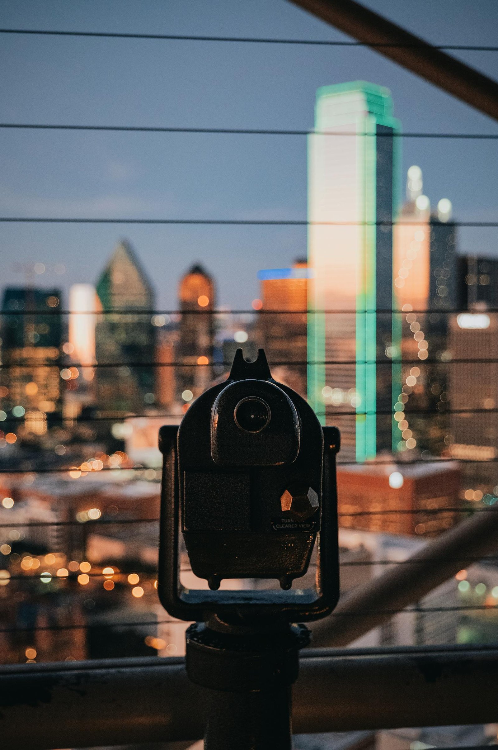 A viewfinder overlooks the Dallas skyline at twilight, capturing the city's modern architecture.